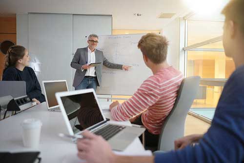 MercuryGate University - The Program - Teacher Using Whiteboard
